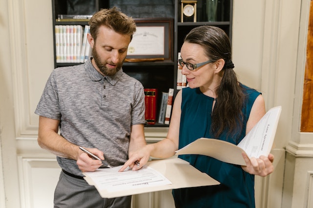 Two lawyers standing and reviewing documents